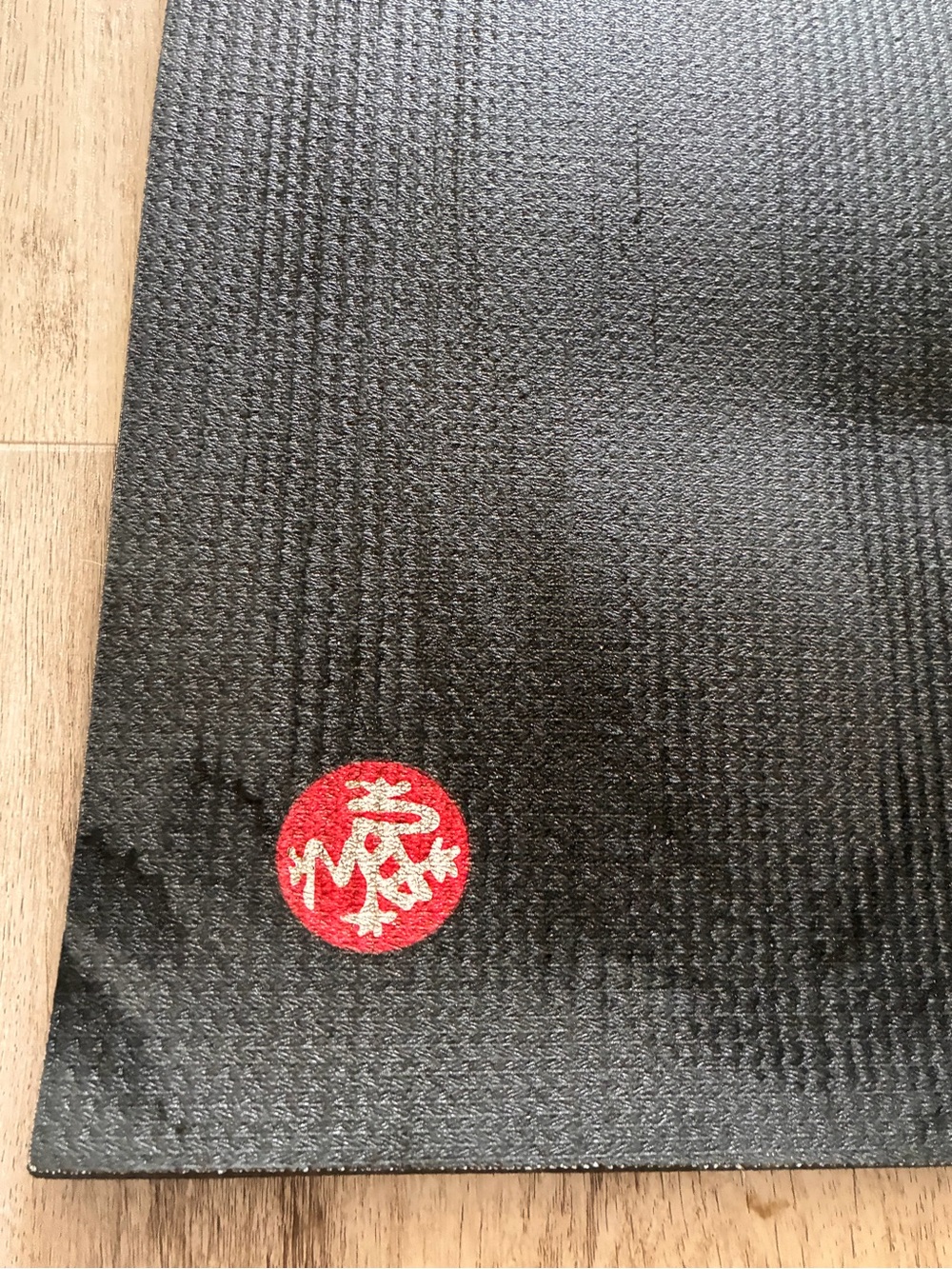 manduka Black Yoga Mat with Red Emblem